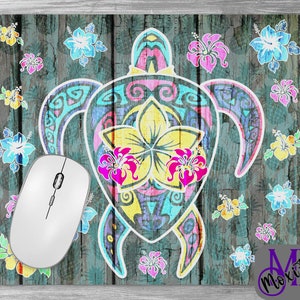 May include: A colorful mousepad with a tribal-style turtle design and floral accents. The turtle is surrounded by hibiscus flowers in shades of pink, yellow, blue, and green. The background is a distressed wood texture.