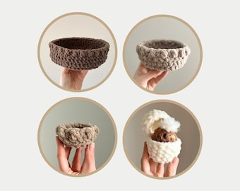 May include: Four crocheted baskets, two brown and two white. The white baskets are shown with a small brown crocheted chick inside.
