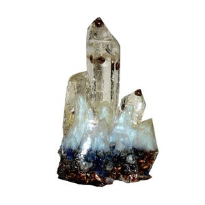May include: A clear quartz crystal cluster with brown inclusions and a blue and white iridescent base. The crystal has a pointed, elongated shape with multiple facets. The base is a mix of dark blue and brown.
