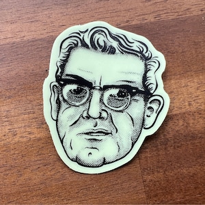 May include: Black and white illustration of a man wearing glasses. The illustration is on a green background.