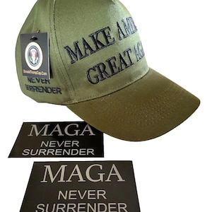 May include: A green baseball cap with black embroidery that reads "Make America Great Again". The cap has a black tag attached to it that reads "DonaldTrumpCap.com Never Surrender". There are two black rectangular stickers that read "MAGA Never Surrender".