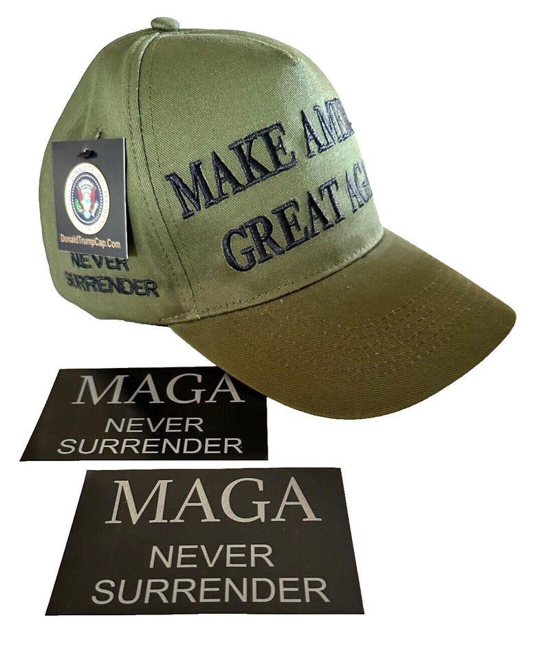 May include: A green baseball cap with black embroidery that reads "Make America Great Again". The cap has a black tag attached to it that reads "DonaldTrumpCap.com Never Surrender". There are two black rectangular stickers that read "MAGA Never Surrender".