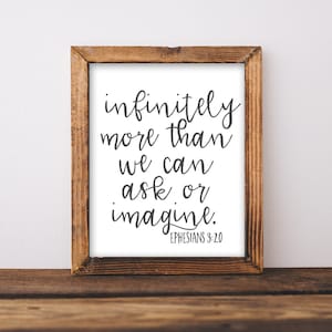 May include: A framed print with a white background and black text that reads "infinitely more than we can ask or imagine. Ephesians 3:20".