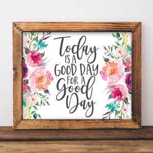 Puede incluir: Una impresión enmarcada con un diseño floral de acuarela y el texto "Today is a good day for a good day".