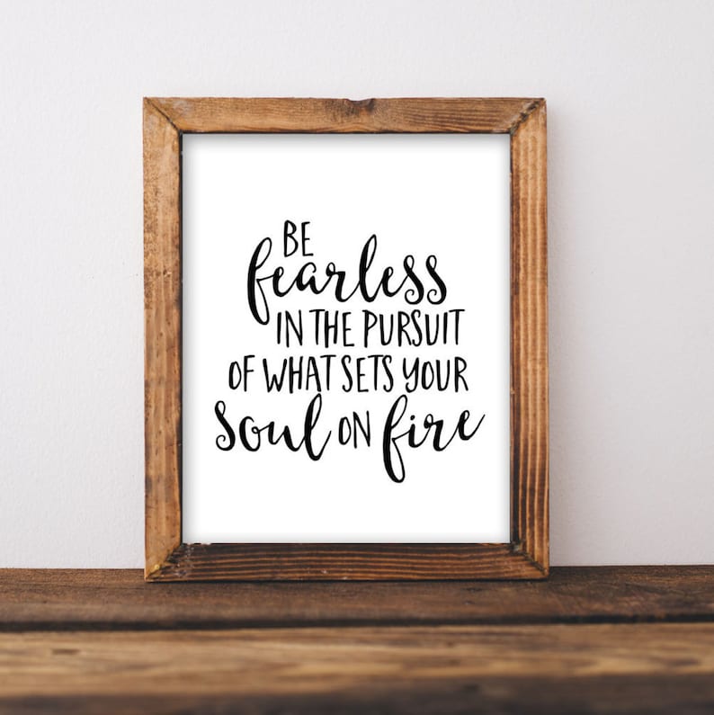 May include: A framed print with a white background and black text that reads "Be fearless in the pursuit of what sets your soul on fire."
