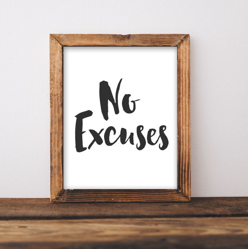 May include: A framed print with the text "No Excuses" in black script font on a white background. The frame is made of brown wood.