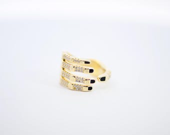 May include: Gold ring with four prongs set with clear cubic zirconia stones.