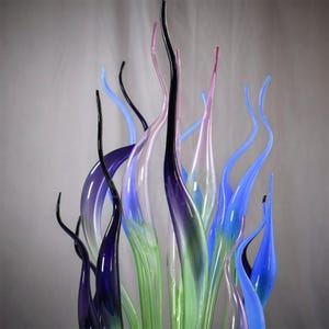 Macro detail of hand-blown glass texture, capturing the smooth, polished surface and subtle light reflections on the flowing organic forms of the sculpture