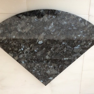 May include: A black and blue granite countertop with a quarter-circle shape.