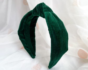 May include: A dark green velvet headband with a knotted bow detail.