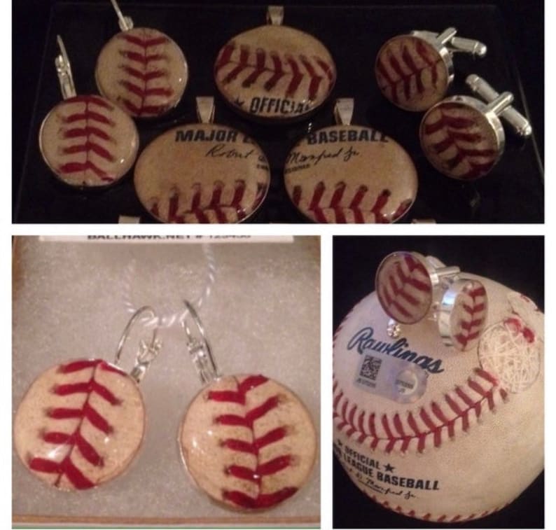 May include: A set of baseball-themed jewellery, including earrings, cufflinks, and a pendant. The jewellery features vintage baseballs with red stitching and a white background. The pendant has the text "Major League Baseball" and "Official" on it.