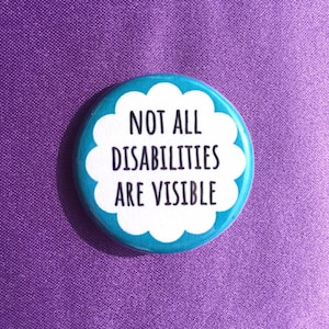 May include: A blue and white button with the text "Not all disabilities are visible" in black lettering.