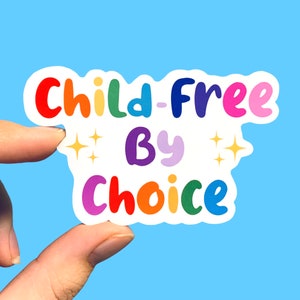 May include: A rainbow-coloured sticker with the text "Child-Free By Choice" in a playful font. The sticker has two small stars on either side of the word "By".