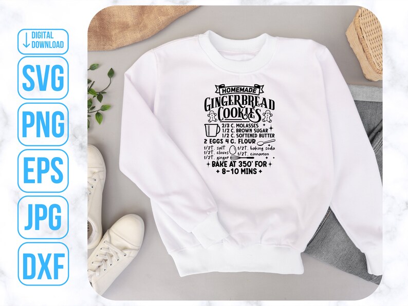 May include: White sweatshirt with black text that reads "HOMEMADE GINGERBREAD COOKIES" and includes a recipe for gingerbread cookies. The recipe includes ingredients such as molasses, brown sugar, softened butter, eggs, flour, salt, cloves, baking soda, ginger, and cinnamon. The recipe also includes instructions to bake at 350 degrees Fahrenheit for 8-10 minutes.