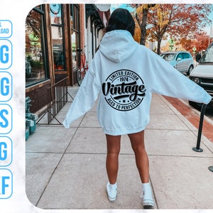 May include: White hooded sweatshirt with black text that reads "Limited Edition - 1974 - Vintage Aged to Perfection".