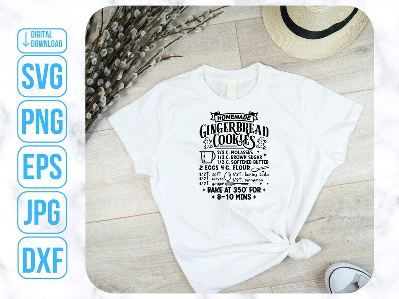 May include: A white t-shirt with a black graphic design that says "Homemade Gingerbread Cookies" and includes a recipe for gingerbread cookies. The recipe includes ingredients like molasses, brown sugar, softened butter, eggs, flour, salt, baking soda, cloves, cinnamon, and ginger. The graphic also includes instructions to bake at 350 degrees Fahrenheit for 8-10 minutes.