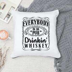 May include: White throw pillow with black text that reads "Everybody in da pub drinkin' whiskey".