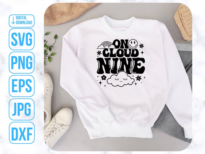 May include: White sweatshirt with black text that reads "On Cloud Nine" with a rainbow, a cloud with eyes, and a smiley face.