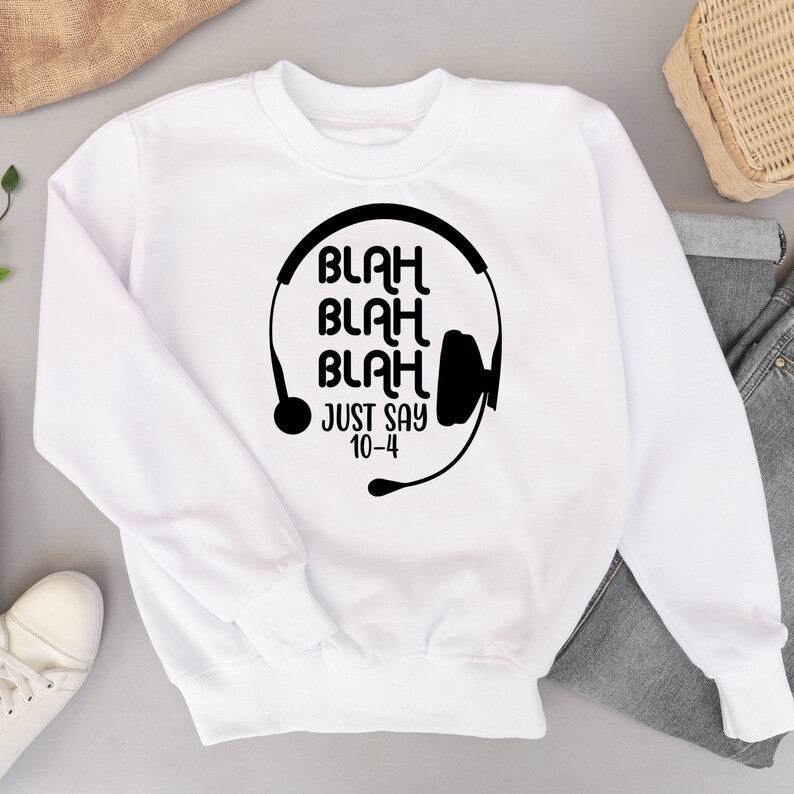 May include: White sweatshirt with a black graphic of a headset with the text "Blah Blah Blah Just Say 10-4"