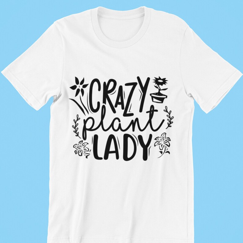 May include: White t-shirt with black text that reads "Crazy Plant Lady" with a flower and potted plant graphic.