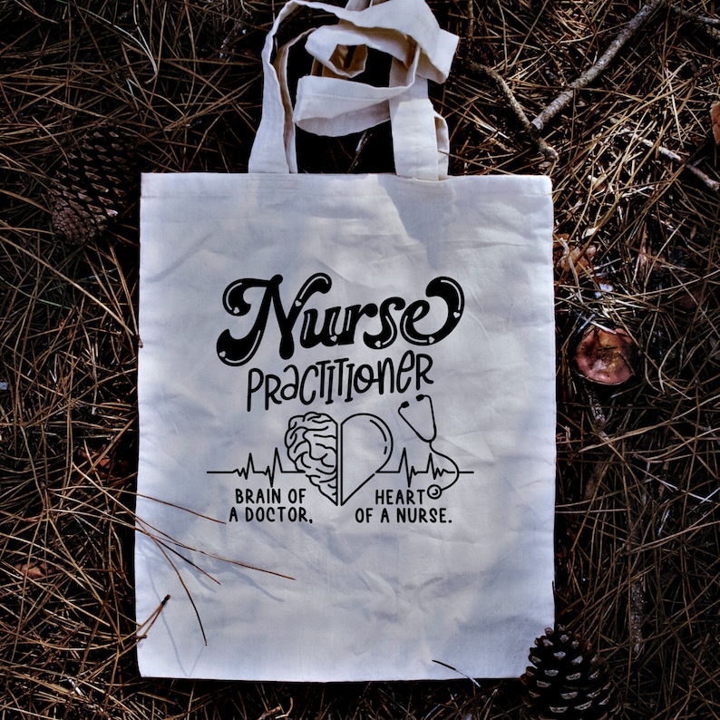 May include: White tote bag with black text that reads "Nurse Practitioner" with a brain and heart graphic and the text "Brain of a Doctor. Heart of a Nurse."
