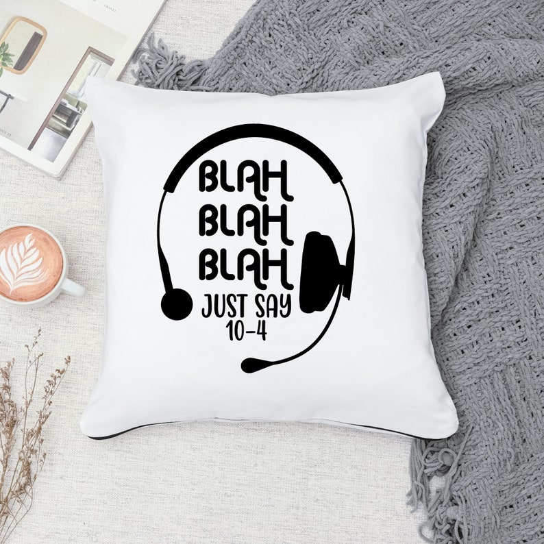 May include: White pillow with black text and a graphic of a headset. The text reads "Blah Blah Blah Just Say 10-4".