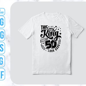May include: White t-shirt with black text that reads "This King Makes 50 Look Good" with a crown and stars.