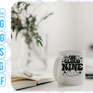May include: White ceramic mug with a black graphic that says "On Cloud Nine" with a cloud and stars.