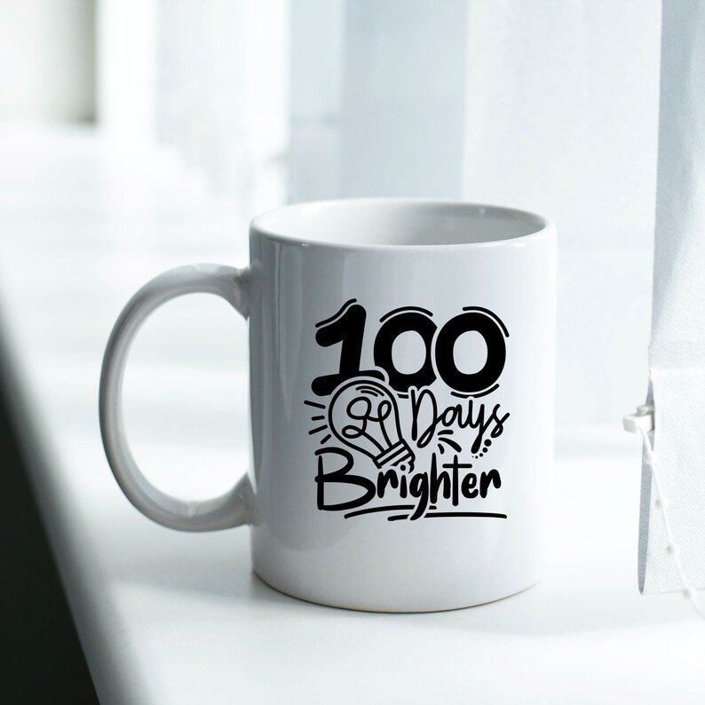 May include: White ceramic mug with a black design that says "100 Days Brighter" with a lightbulb graphic.