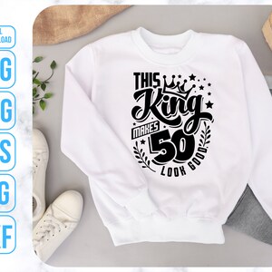 May include: White sweatshirt with black text that reads "This King Makes 50 Look Good" with a crown and stars.