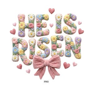 May include: An embroidered design with the words "HE IS RISEN" in pastel colors, decorated with flowers and hearts. A pink bow is at the bottom. The image is on a white background.