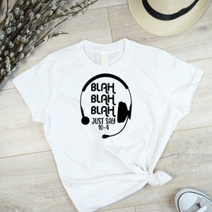 May include: White t-shirt with a black graphic of a headset and the text "Blah Blah Blah Just Say 10-4"