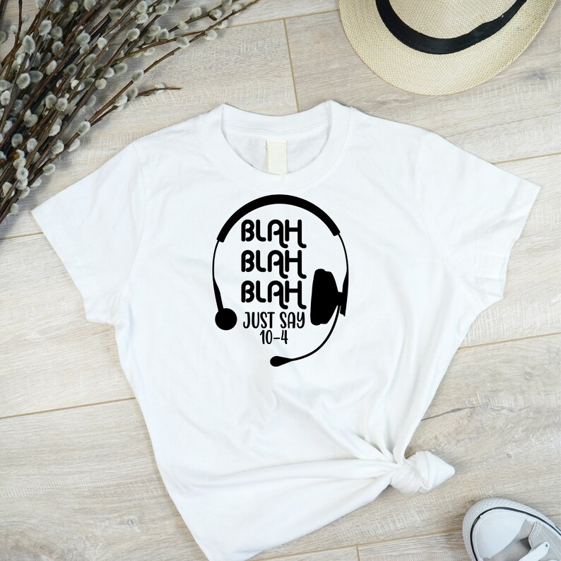 May include: White t-shirt with a black graphic of a headset and the text "Blah Blah Blah Just Say 10-4"