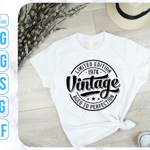May include: White t-shirt with a black circle graphic that says "Limited Edition 1974 Vintage Aged to Perfection".