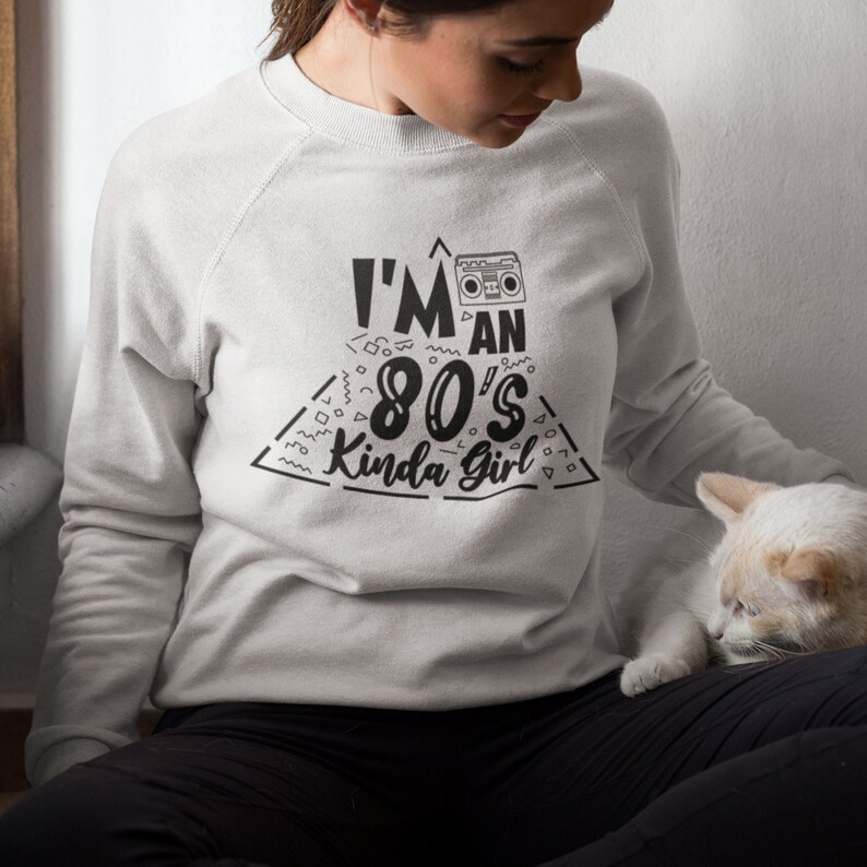 May include: A gray sweatshirt with a black graphic print that says "I'm an 80's Kinda Girl" with a retro boombox graphic.