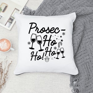 May include: White throw pillow with black text that reads "Prosec-Ho Ho! Ho!" with a snowman and wine glasses.