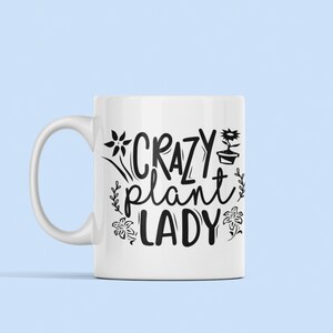 May include: White ceramic mug with a black design that says "Crazy Plant Lady" with stylized flowers and a potted plant.