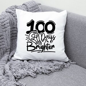 May include: White throw pillow with black text that reads "100 Days Brighter" with a lightbulb graphic.