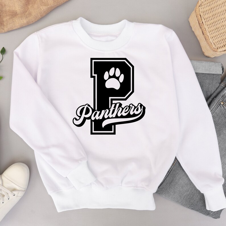 May include: White sweatshirt with a black paw print inside a black letter "P" and the word "Panthers" in a black script font.