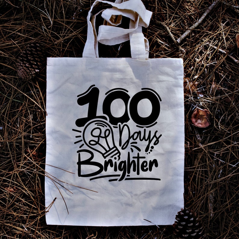May include: White canvas tote bag with black text that reads "100 Days Brighter" and a lightbulb graphic.