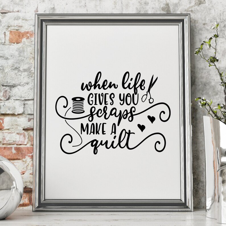 May include: Black and white printable wall art with a quote about quilting: "When life gives you scraps, make a quilt". The quote is surrounded by decorative swirls and includes a spool of thread and scissors.