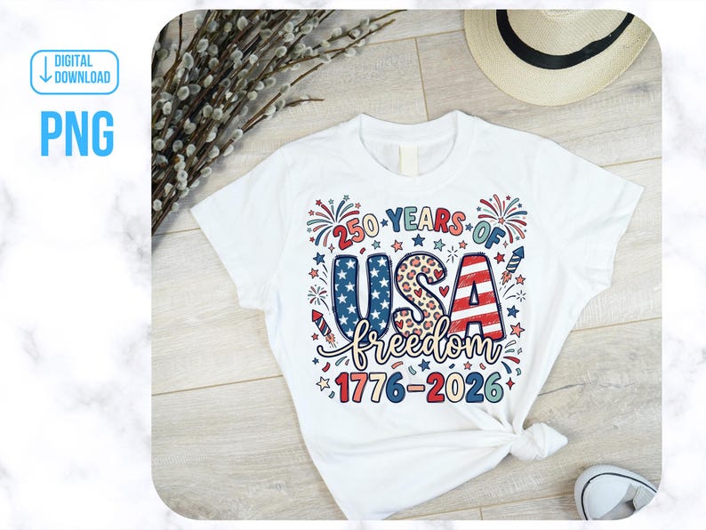 May include: White t-shirt featuring a patriotic design celebrating 250 years of USA freedom. The graphic includes the text "250 YEARS OF USA freedom 1776-2026" in red, white, and blue, with stars, fireworks, and a leopard print pattern.