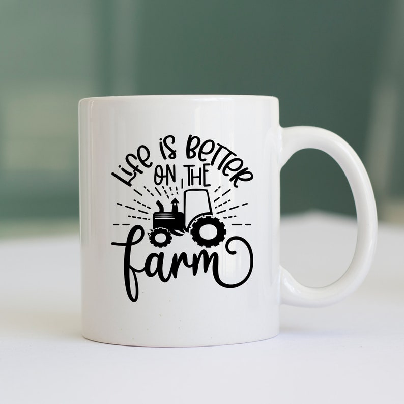 May include: White ceramic mug with a black design that says "Life is better on the farm" with a tractor graphic.