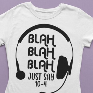 May include: White t-shirt with a black graphic of a headset and the text "Blah Blah Blah Just Say 10-4".