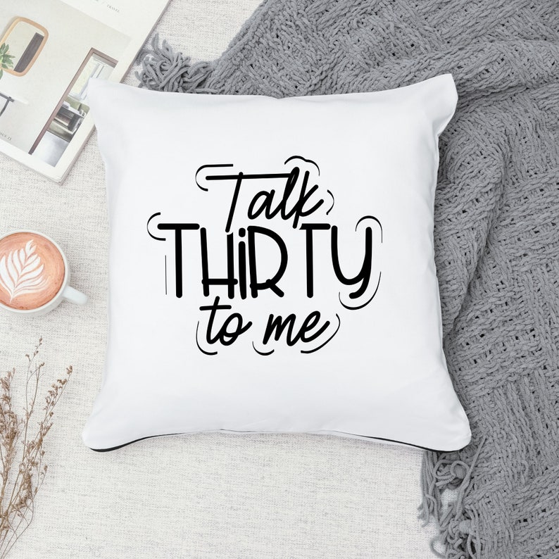 May include: White cushion with black text that reads "Talk Thirty to Me".