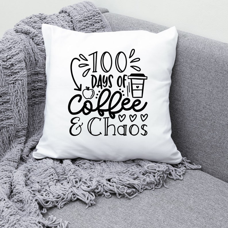 May include: White throw pillow with black text that reads "100 Days of Coffee & Chaos". The text is stylized with a coffee cup, apple, and hearts.
