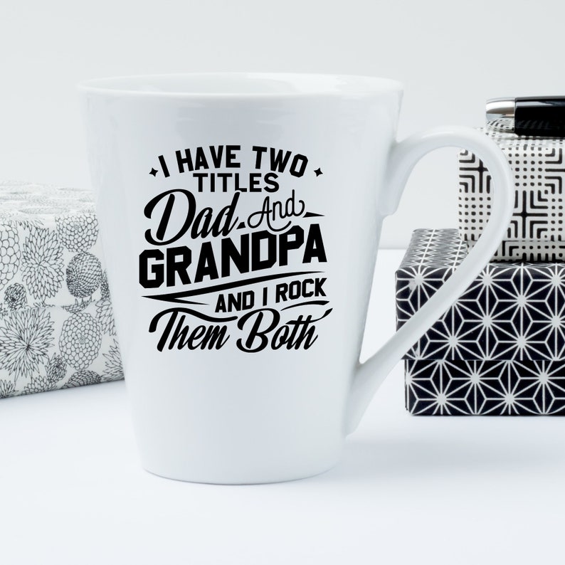 May include: White ceramic coffee mug with a black design that reads "I have two titles Dad and Grandpa and I rock them both".