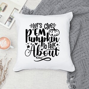 May include: White throw pillow with black text that reads "Let's give 'em pumpkin to talk about" with a small black pumpkin graphic.
