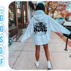 May include: A white hoodie with black text that reads "On Cloud Nine" with a smiley face and a cloud graphic.
