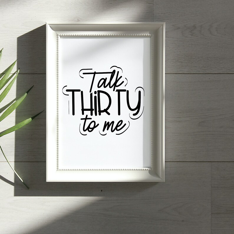 May include: White framed print with black text that reads "Talk Thirty to Me".